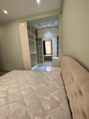 a bedroom with a large bed in a room at Buzovna Delmar Luxury Residence in Mardakan