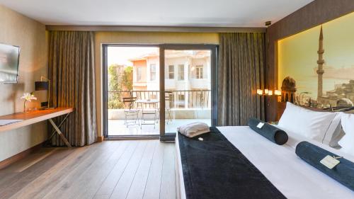a hotel room with a bed and a balcony at Hotel Saint Sophia in Istanbul