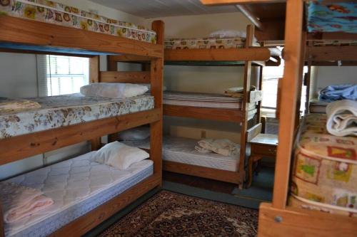 a room with four bunk beds in a house at Beaufort Harbour Suites West Lodge in Beaufort