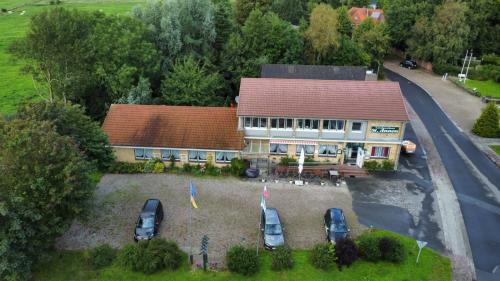an aerial view of a house with cars parked in front at Landgasthaus Sankt Annen in Sankt Annen