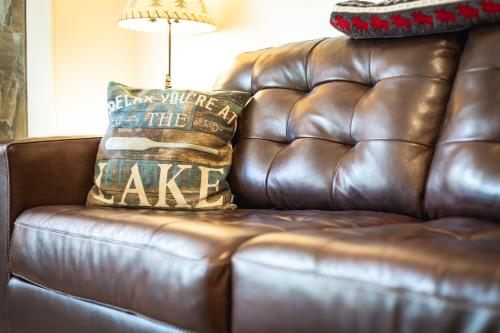 a brown leather couch with two pillows on it at Heavenly Lakeside Retreat Close to downtown in South Lake Tahoe
