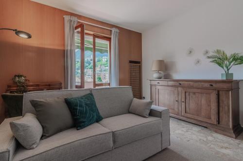 a living room with a couch and a window at Casa Breggia in Cernobbio