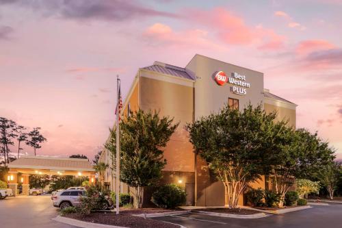 a front view of a hotel with a krispy kreme sign at Best Western Plus Wilmington / Wrightsville Beach in Wilmington