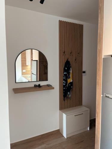 a room with a mirror on a wall next to a refrigerator at Lavender Apartment - Close to the Beach - Private Garage Parking in Dobra Voda