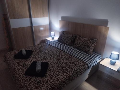 a bedroom with a bed with a checkered bedspread at Skopje Sky Apartments & Floor 33th 28th & 25th & 19th & 13th 12th With Pool & Spa & Fitness & Parking Included in Price in Skopje