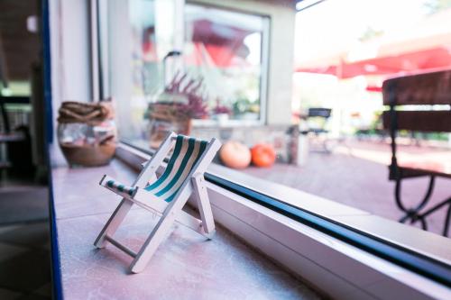 a striped chair sitting in a window of a store at Gościniec pod Żaglami in Skoki Duże