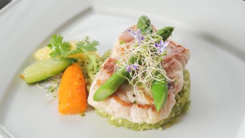 a plate of food with sushi and vegetables on it at Barceló Santo Domingo in Santo Domingo