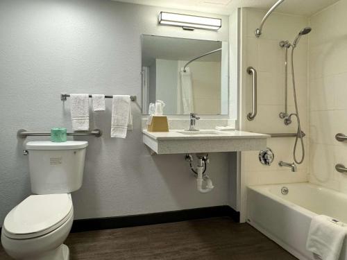 a bathroom with a toilet and a sink and a tub at Motel 6 Huntsville AL University Dr. in Huntsville