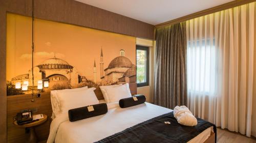 a hotel room with a bed with a picture on the wall at Hotel Saint Sophia in Istanbul
