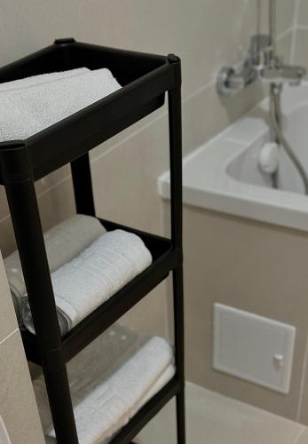 a towel rack in a bathroom with a sink at AMB Residence Luxury Pipera in Voluntari