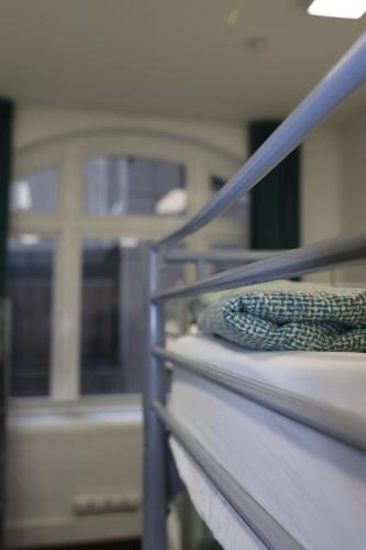 a bed in a hospital room with at Nomads Sydney in Sydney