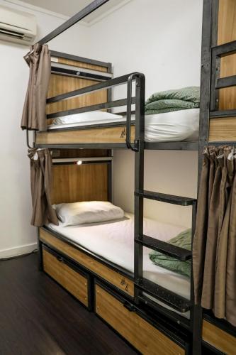 a bedroom with bunk beds in a hostel at Nomads Sydney in Sydney