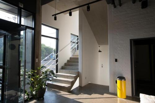 a staircase in a house with a yellow trash can at Baguni Hostel in Suncheon