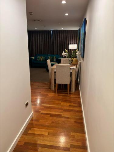 a hallway with a dining room and a living room at Museum Apartment in Wellington