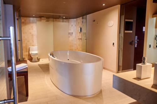 a large white tub in a bathroom with a toilet at Casa Andina Premium Golf Los Incas in Lima