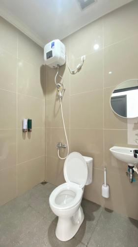 a bathroom with a toilet and a sink at Eben Haezer Villas in Karangploso