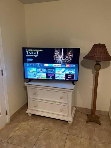a tv on top of a dresser with a lamp at 12 South Harbor View in Georgetown