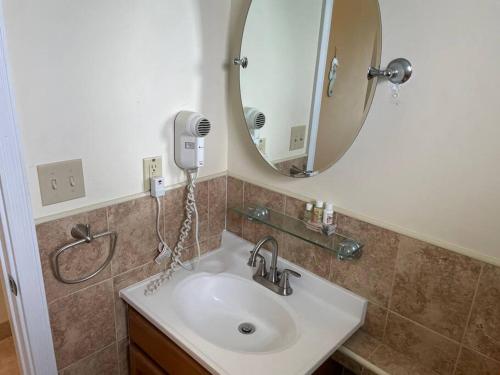 a bathroom with a sink and a mirror at 12 South Harbor View in Georgetown