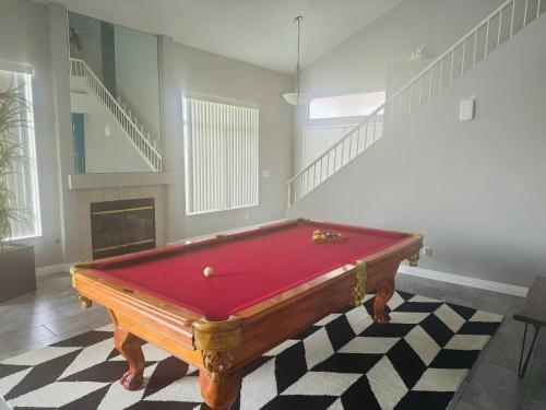 a red pool table in a room with a fireplace at Paradise in Las Vegas