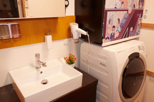 a bathroom with a sink and a washing machine at TokyoKoso Vacation Home in Tokyo