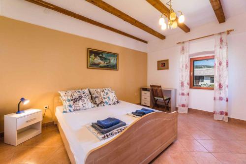a bedroom with a bed and a desk and a window at Apartment in Bribir 41909 in Bribir