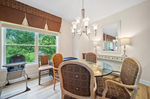 a dining room with a table and chairs and a mirror at Private, Gatlinburg Bliss with Hot Tub and City Views in Gatlinburg