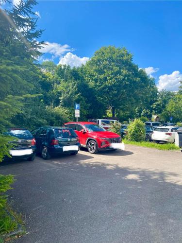 a group of cars parked in a parking lot at Stilvolles Apartment mit Balkon, Küche & Parkplatz - Waldstetten Zentrum in Waldstetten