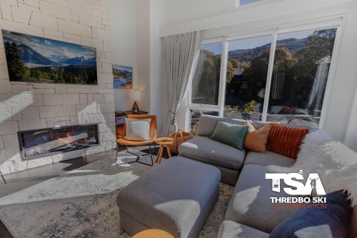 a living room with a couch and a fireplace at Akuna 3 in Thredbo