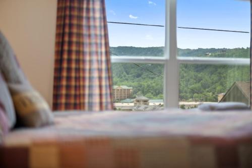 a window with a view of a mountain view at Private, Gatlinburg Bliss with Hot Tub and City Views in Gatlinburg