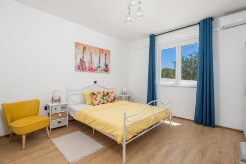 a bedroom with a bed and a chair and a window at Holiday home in Slivnica - Paklenica Riviera 44875 in Slivnica