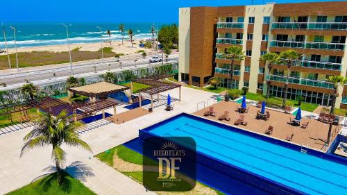 an aerial view of a hotel with a pool and the beach at Vg Fun by Diego Flats in Fortaleza