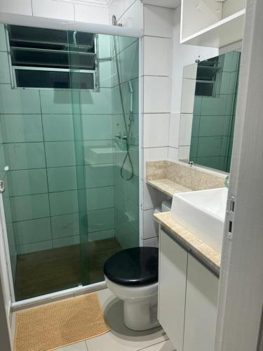 a bathroom with a toilet with a glass shower at Apê 102, ao lado da Graal, Dutra e próximo da Amam in Resende