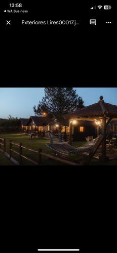a picture of a house with lights on at Cabañas de Lires in Lires