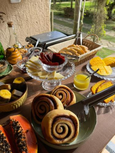 a table topped with plates of pastries and other foods at Sítio Terra Sana in Santa Teresa