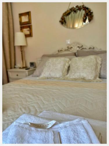 a bedroom with a bed with a thermometer on it at villa MeDITeRAN in Pefkohori