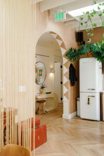 a living room with a refrigerator and a table at Hotel No-Vacancy in Kansas City