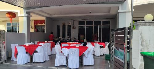 a group of tables and chairs with red and white table cloth at ankang in Alor Setar