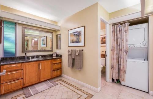 a bathroom with a sink and a tub and a shower at Maui Eldorado - L-105 - in Kahana
