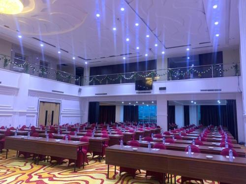 a large room filled with tables and chairs at Travellers Hotel Phinisi in Makassar