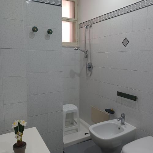a bathroom with a shower and a toilet and a sink at Casa vacanza 'A casa dei Nonni 1' in Belpasso