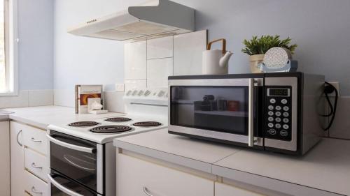 a microwave oven sitting on top of a kitchen counter at 54 Bunga Street in Bermagui