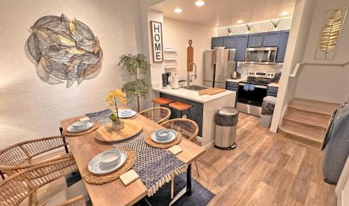 a kitchen and dining room with a table and chairs at Villas at Seven Dwarfs Resort - Near to Disney in Kissimmee