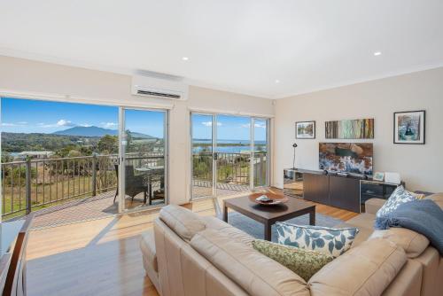 a living room with a couch and a balcony at Seascape 3-7 in Bermagui