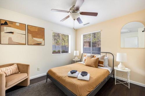 a bedroom with a bed and a ceiling fan at Wooded Oasis, Hot Tub, Fenced Yard, Chic Design in Mountainaire