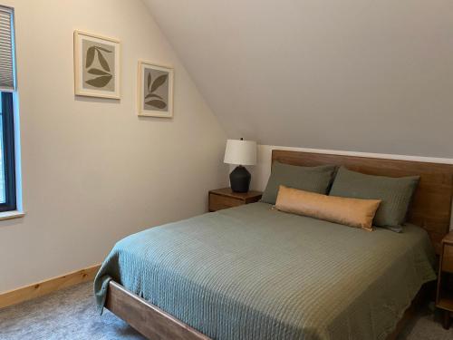 a bedroom with a bed and a window at Bearded Buffalo Resort in Custer