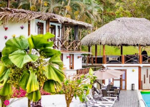 a resort with a swimming pool and a building at Ranchos de Chalia Panama in Portobelo