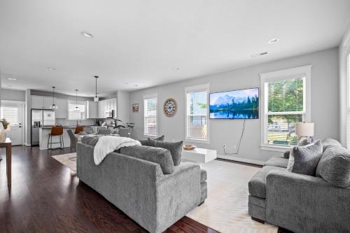 a living room with two couches and a kitchen at Downtown Richmond, Cozy 3BR, Near VCU in Richmond