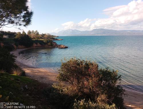 a large body of water with mountains in the background at Geralis Lodge in Chalkida