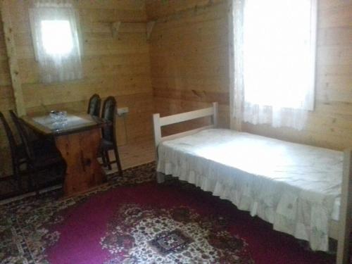 a bedroom with a bed and a table and a window at Prokletije Vucetic sobe in Dolja