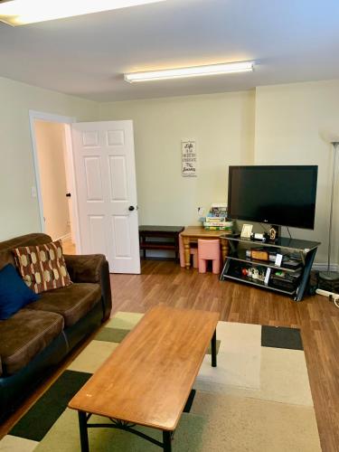 a living room with a couch and a coffee table at Faithful Home in Halifax